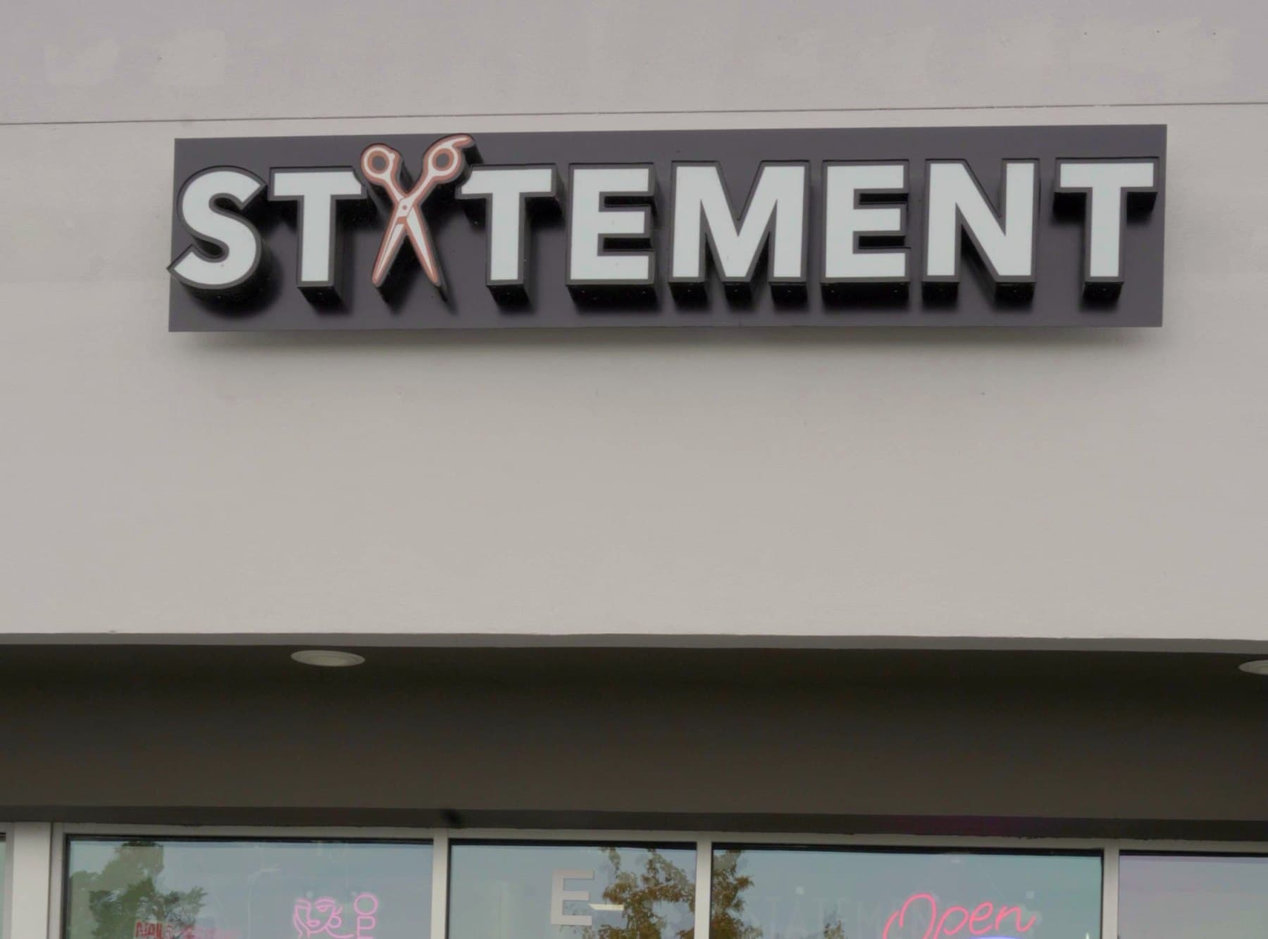 Statement Barber & Salon sign above the shop windows on W Canal Dr in Kennewick, WA